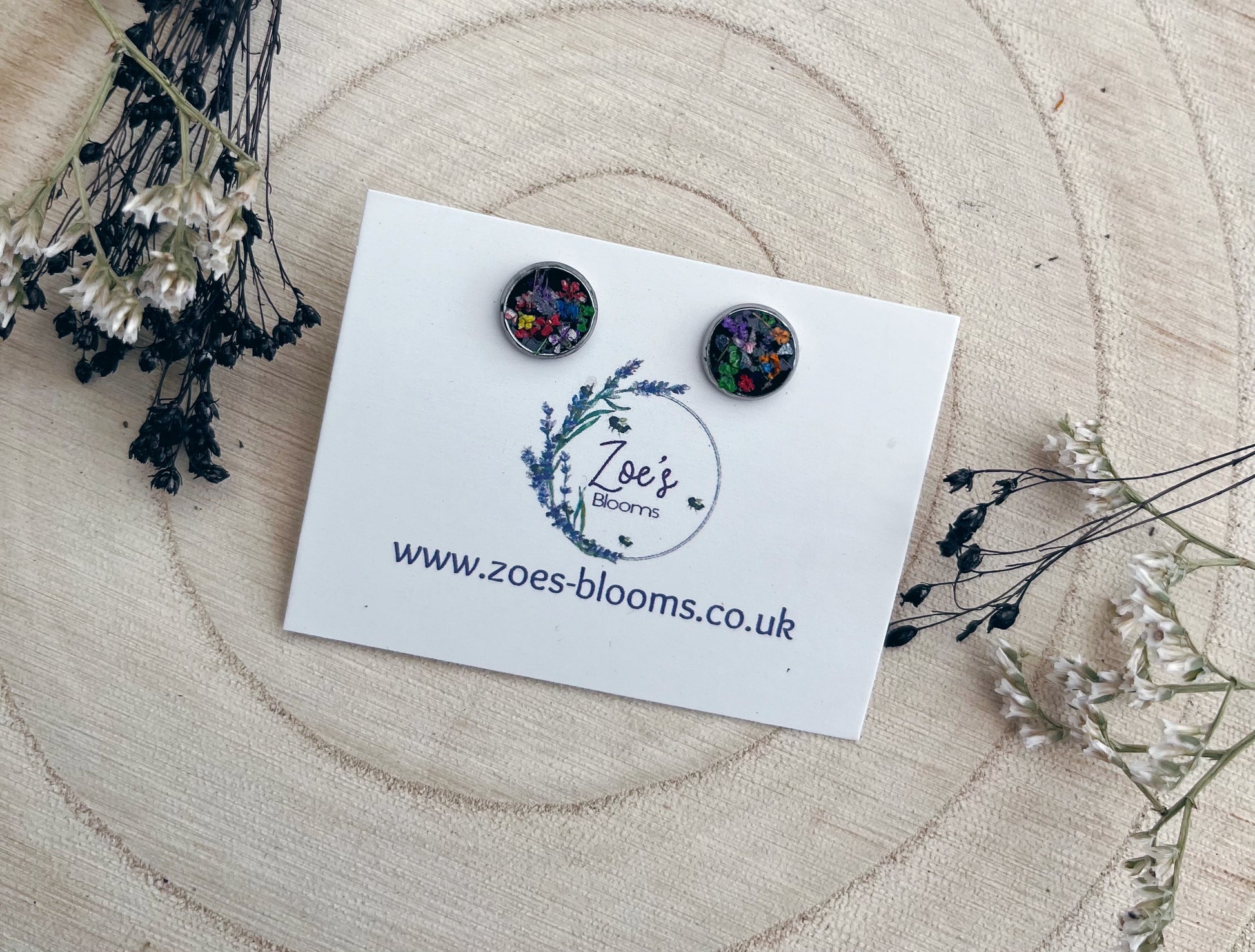 Black resin studs filled with pressed flowers.