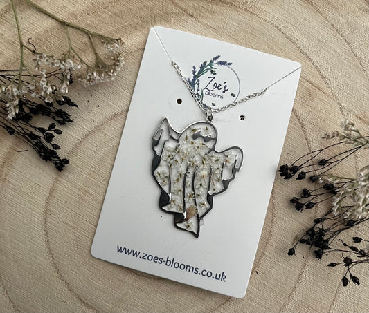 Ghost shaped pendant with pressed flowers, encased in resin