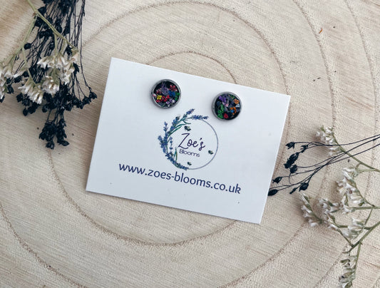 Black resin studs filled with pressed flowers. 